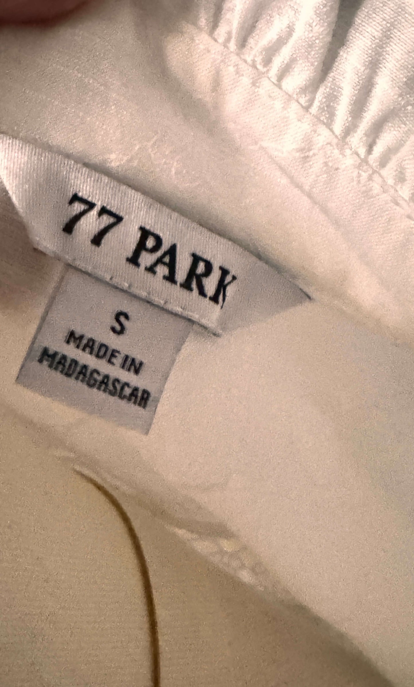 Label of a 77 Park blouse, size small, made in Madagascar, showcasing its brand and sizing for fashion enthusiasts.