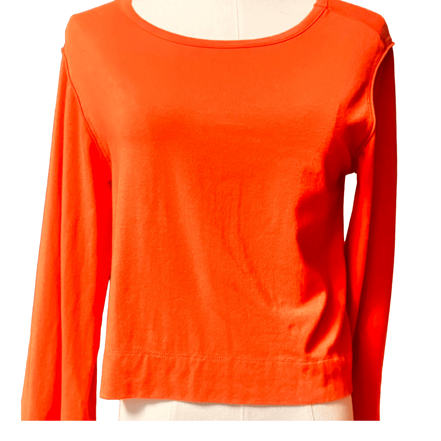 Orange long-sleeve shirt on a mannequin against a white background