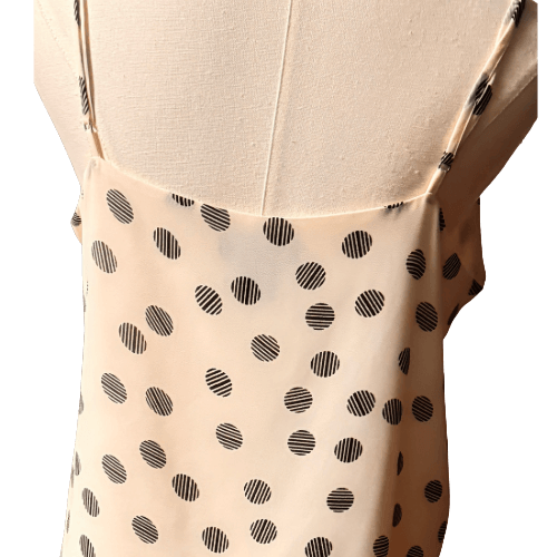 Beige top with black polka dot pattern on a mannequin