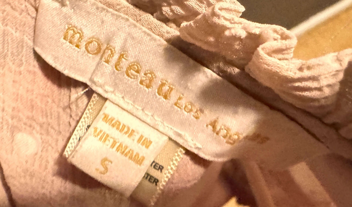 Monteau Los Angeles pink blouse label showcasing size small petite and care instructions.