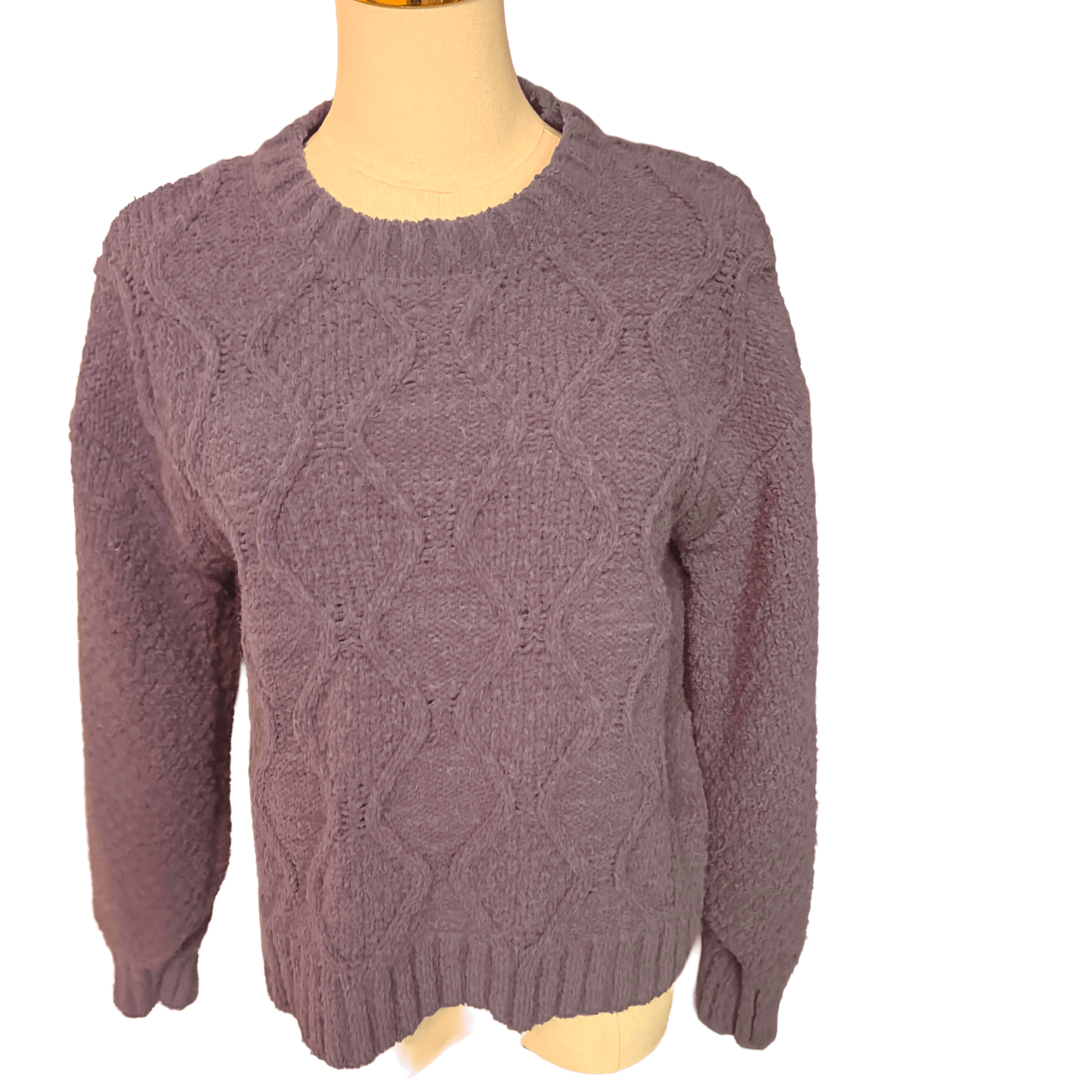 blue cable knit sweater on a mannequin against a white background