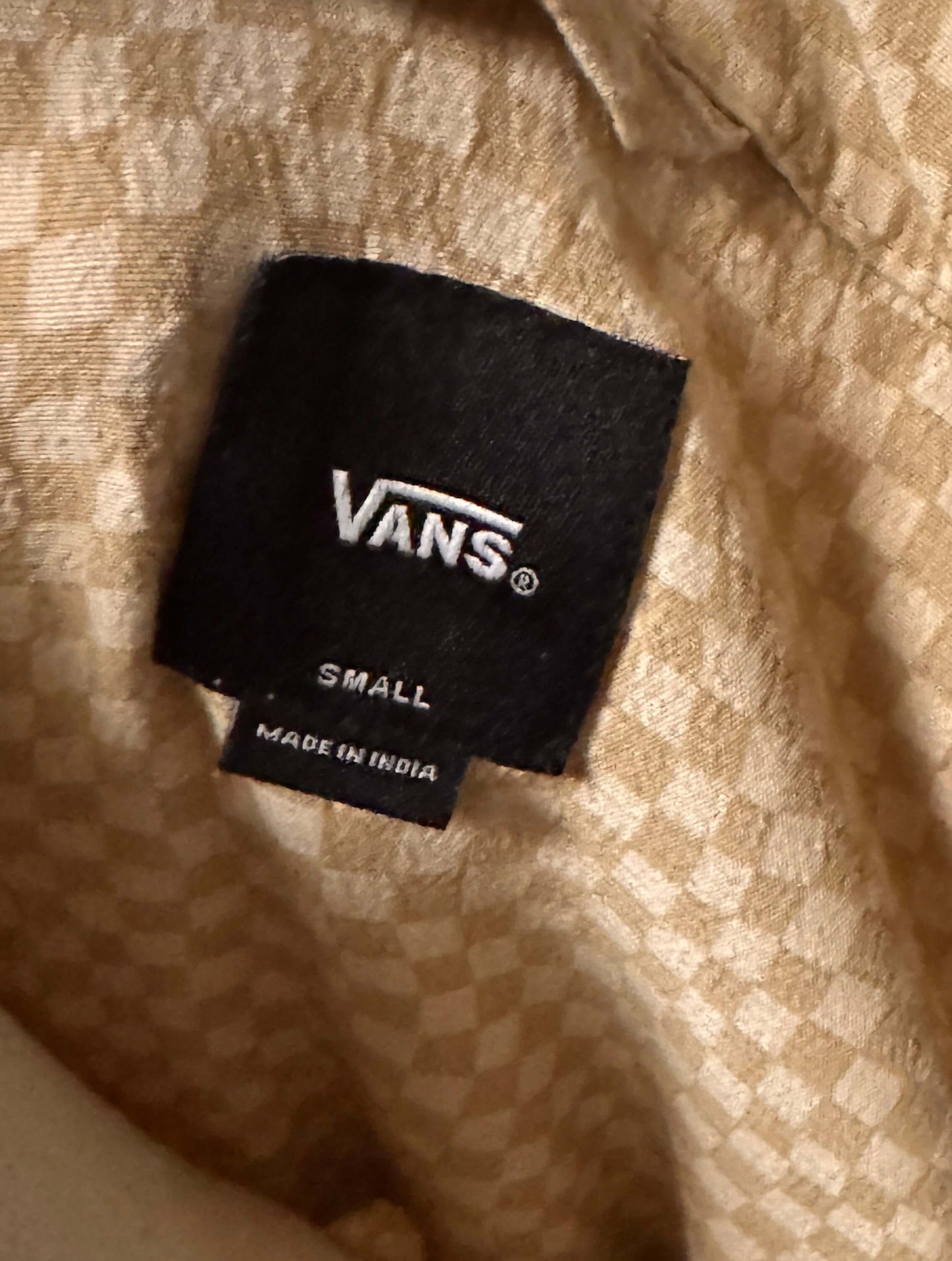 Vans label on a beige textured fabric