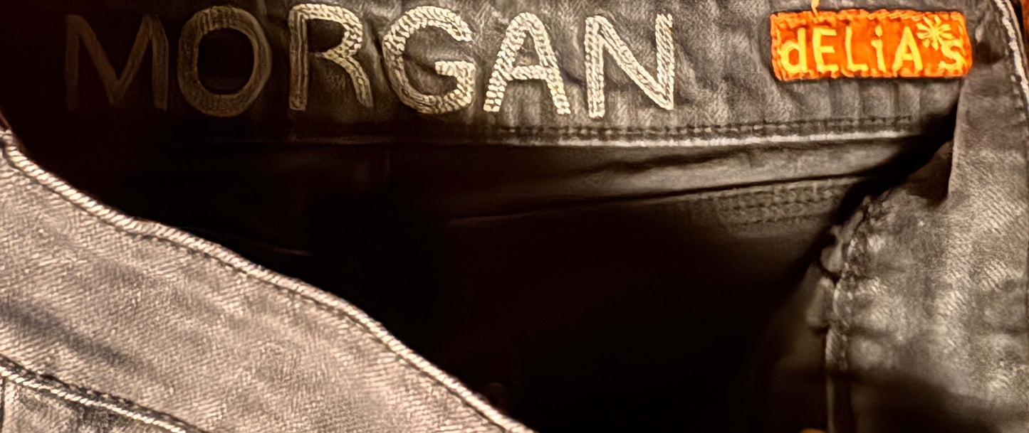 Close-up of a denim pants with 'Morgan' and 'Delia's branding.