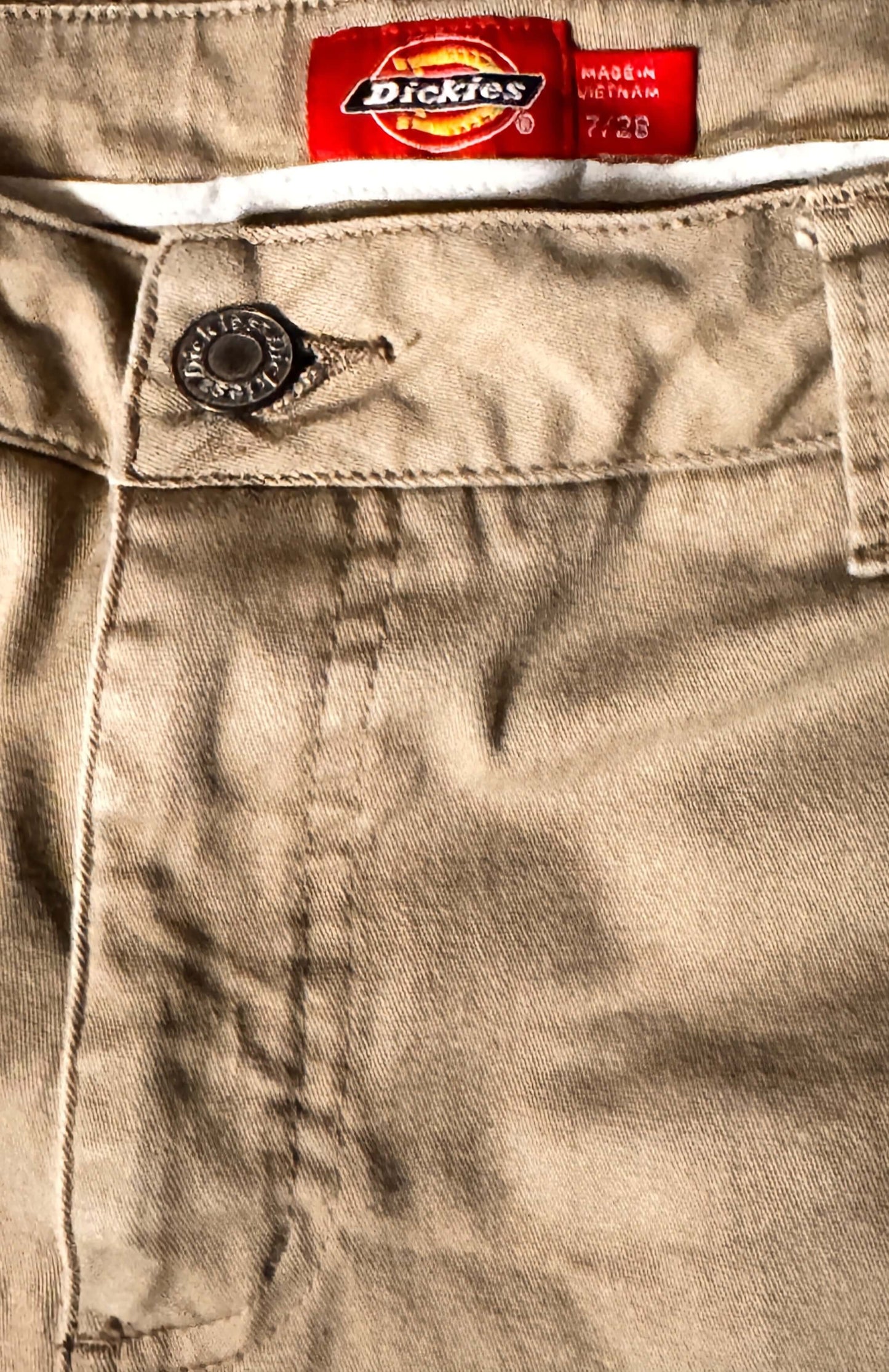 Close-up of Dickies logo on a beige denim pocket