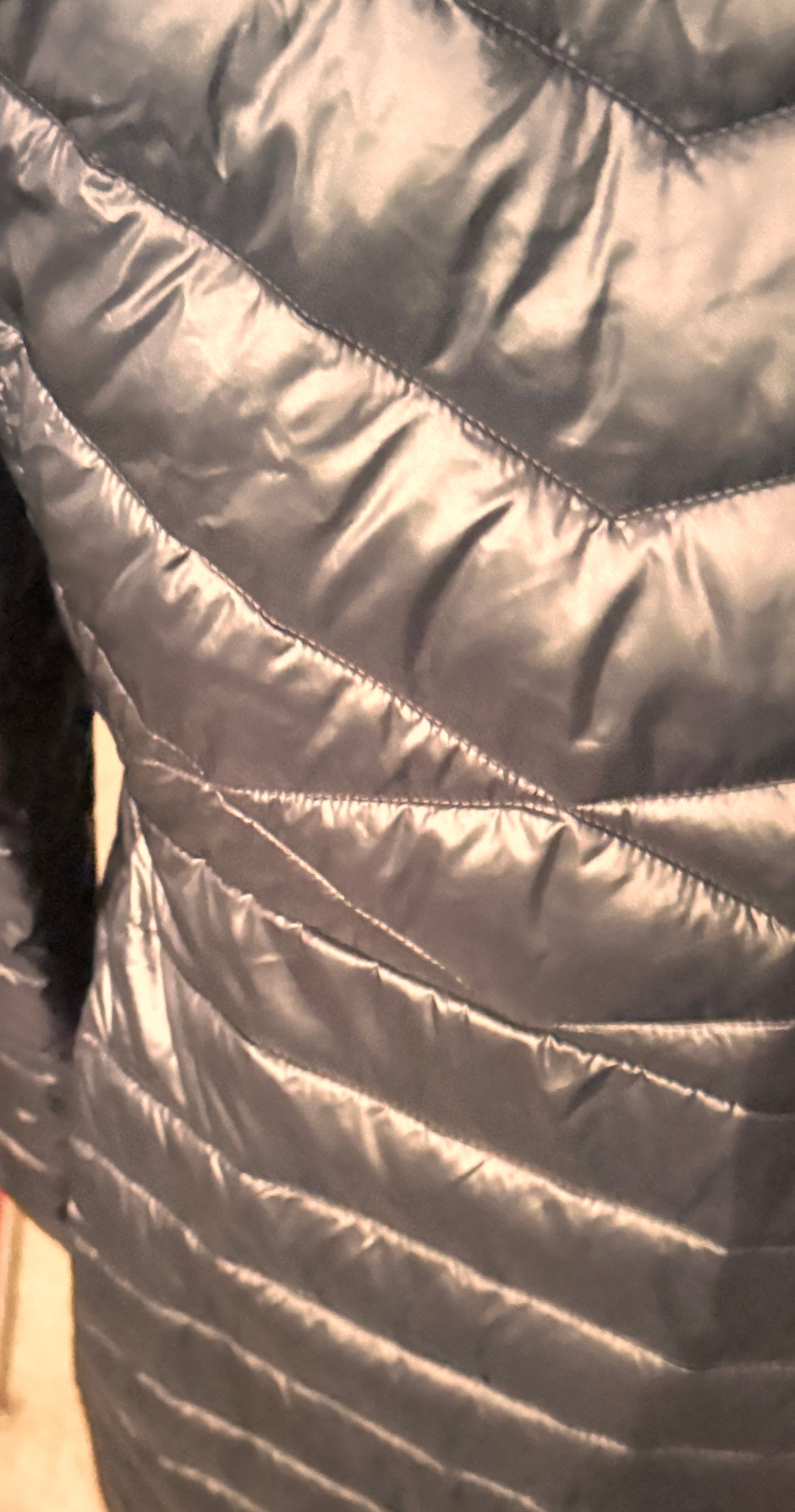 Close-up of a quilted jacket with a neutral color.