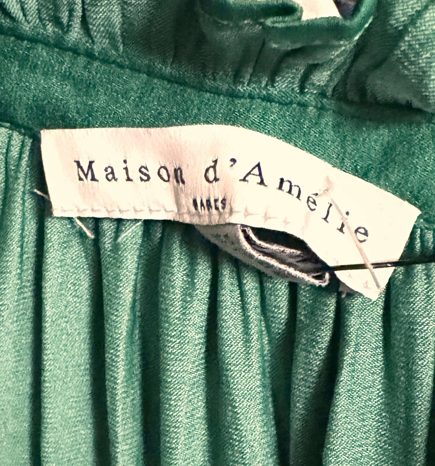 Maison D'Amelie green blouse tag, showcasing brand name and fabric texture, perfect for small petite size.