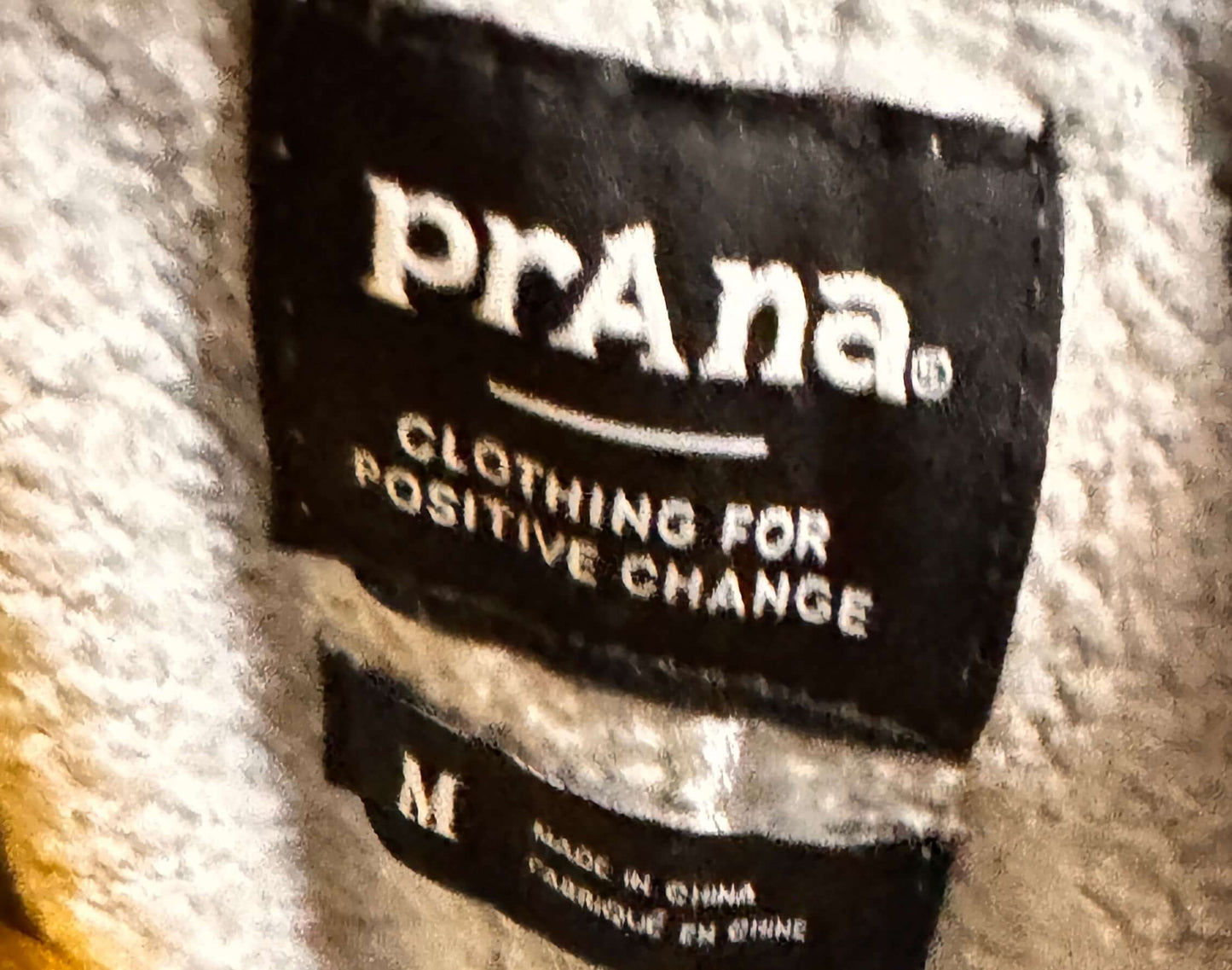 Close-up of a PrAna label on a sweatshirt.
