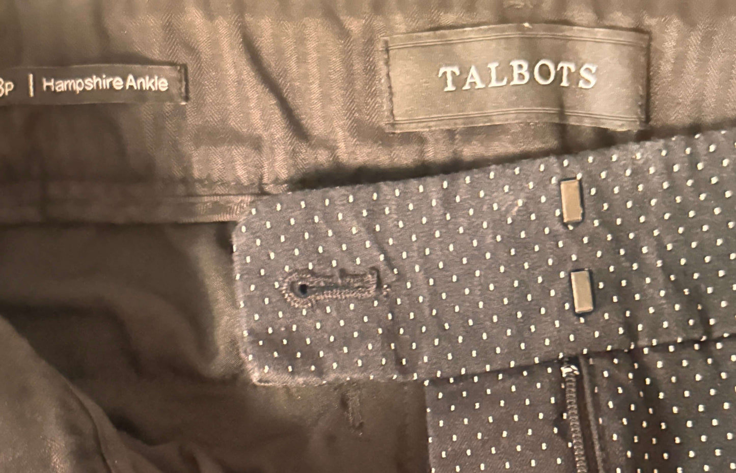 Close-up of a Talbots label on a garment with a polka dot pattern.