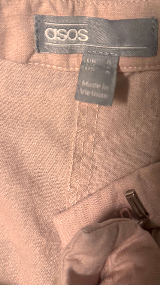ASOS label on women's pale pink shorts, size 4 petite, made in Vietnam.