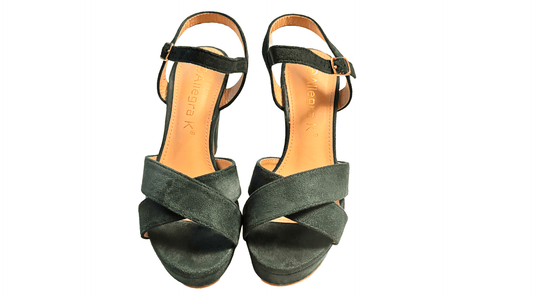 Pair of green high-heeled sandals on a white background
