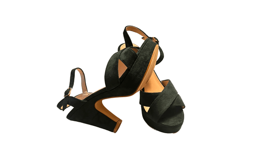 Green high-heeled sandals with cut-out design on a white background