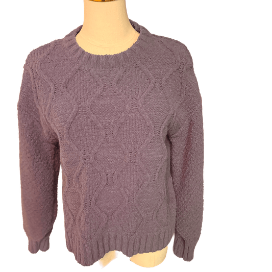 blue cable knit sweater on a mannequin against a white background