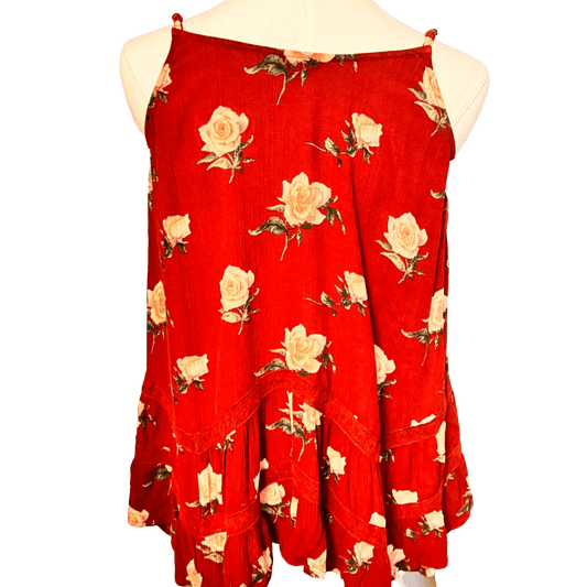 Red sleeveless top with floral pattern on a white background