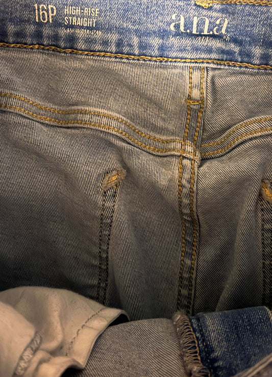 Close-up of blue jeans with brand logo and size label.