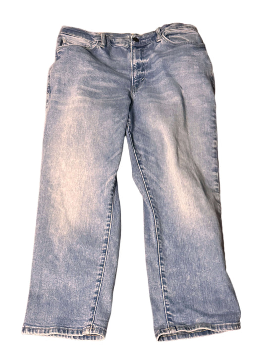 Pair of blue jeans on a patterned red and orange rug