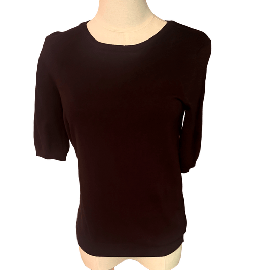 Black sweater on a mannequin against a white background