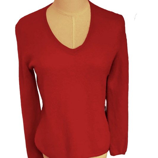 Red long-sleeve top on a mannequin with a white background