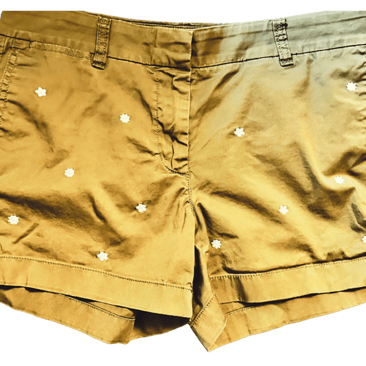 greenish brown shorts with white floral patterns on a white background