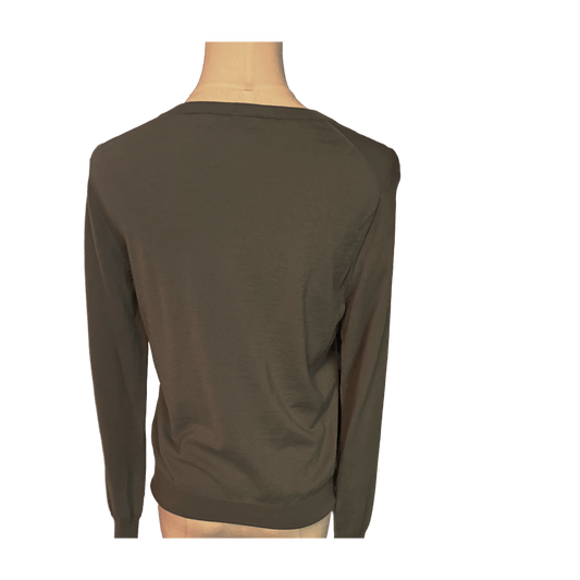 Green long-sleeve shirt on a mannequin against a white background