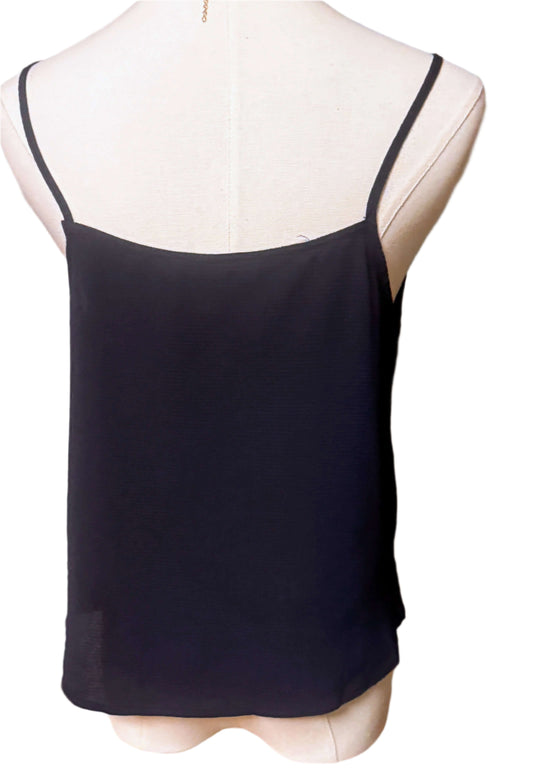 Back view of a black sleeveless blouse, highlighting its simple design and lightweight fabric.