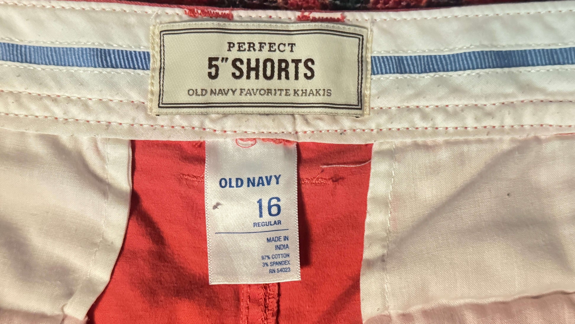 Close-up of Old Navy shorts with a label on a beige background