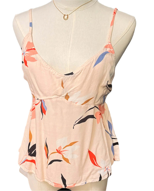 Floral-patterned top on a mannequin against a black background