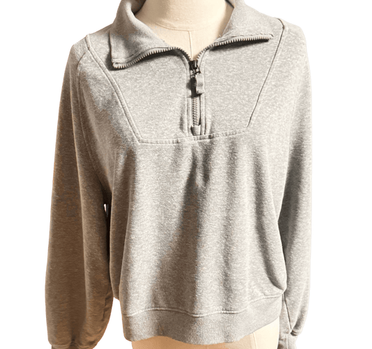 Gray pullover with a quarter zip on a mannequin against a white background